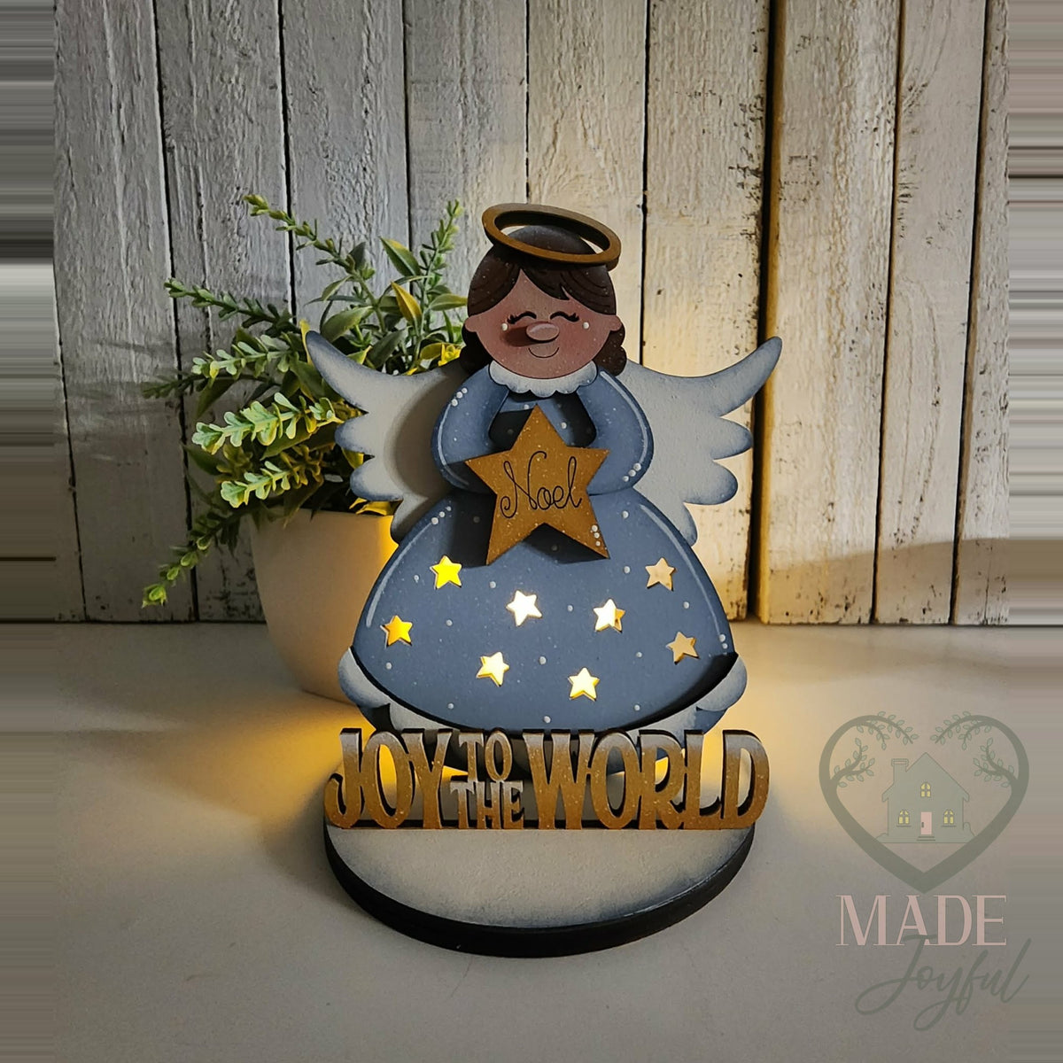 Angel votive glowing through star cut-outs, hand-painted in Brentwood, TN.