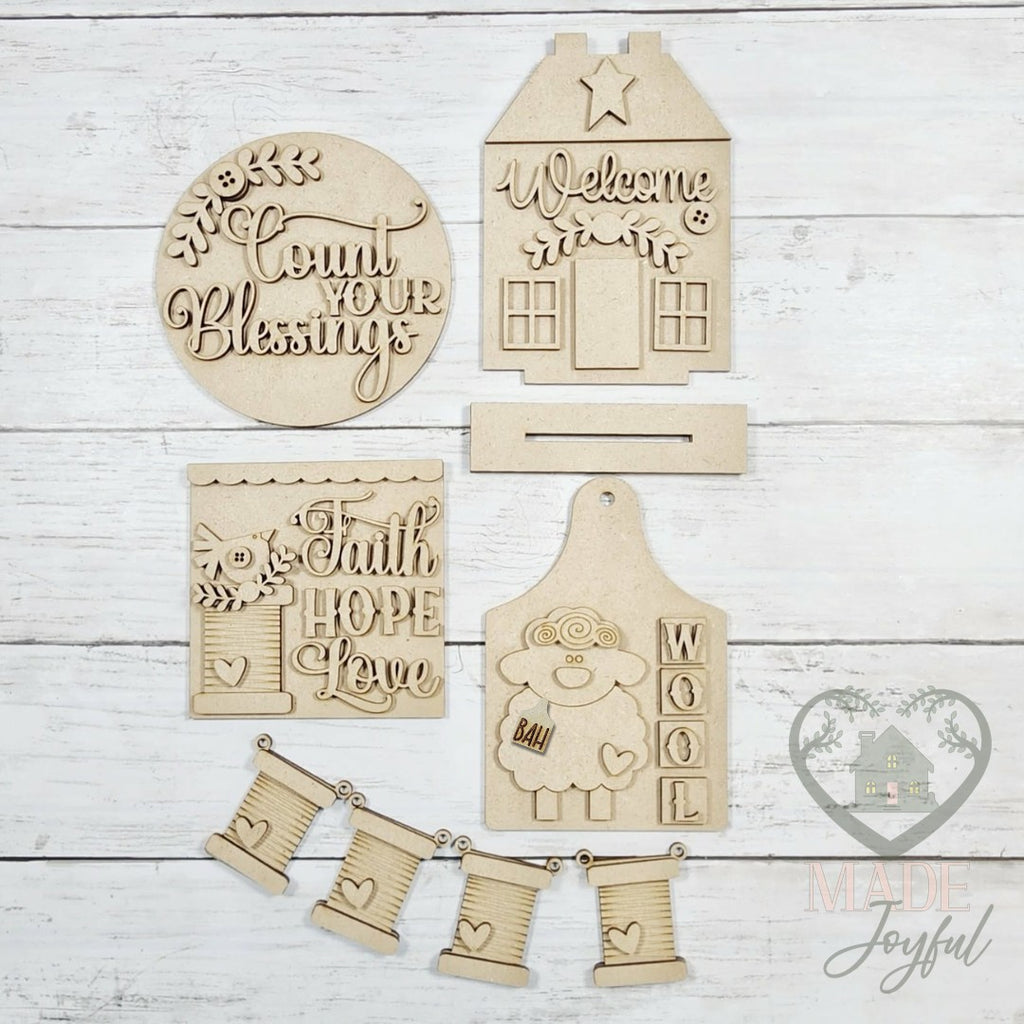 Unfinished laser-cut wood Heirloom Folk Art Tiered Tray Decor Set DIY kit, ready to paint at a DIY party in Williamson County, TN.