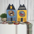 Blue and yellow saltbox house displays with folk art rounds, hand-painted in Brentwood, TN.