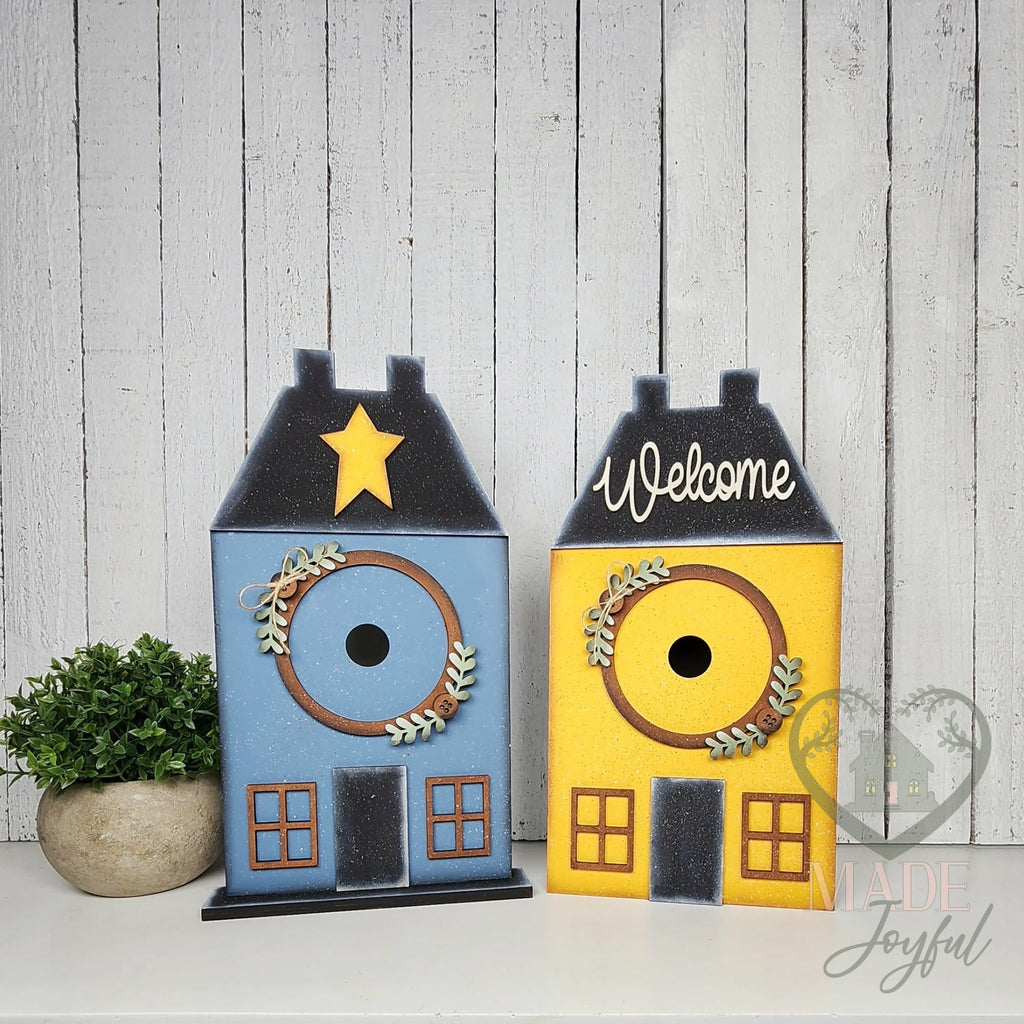 Saltbox house displays in blue and yellow, hand-painted in Brentwood, TN.