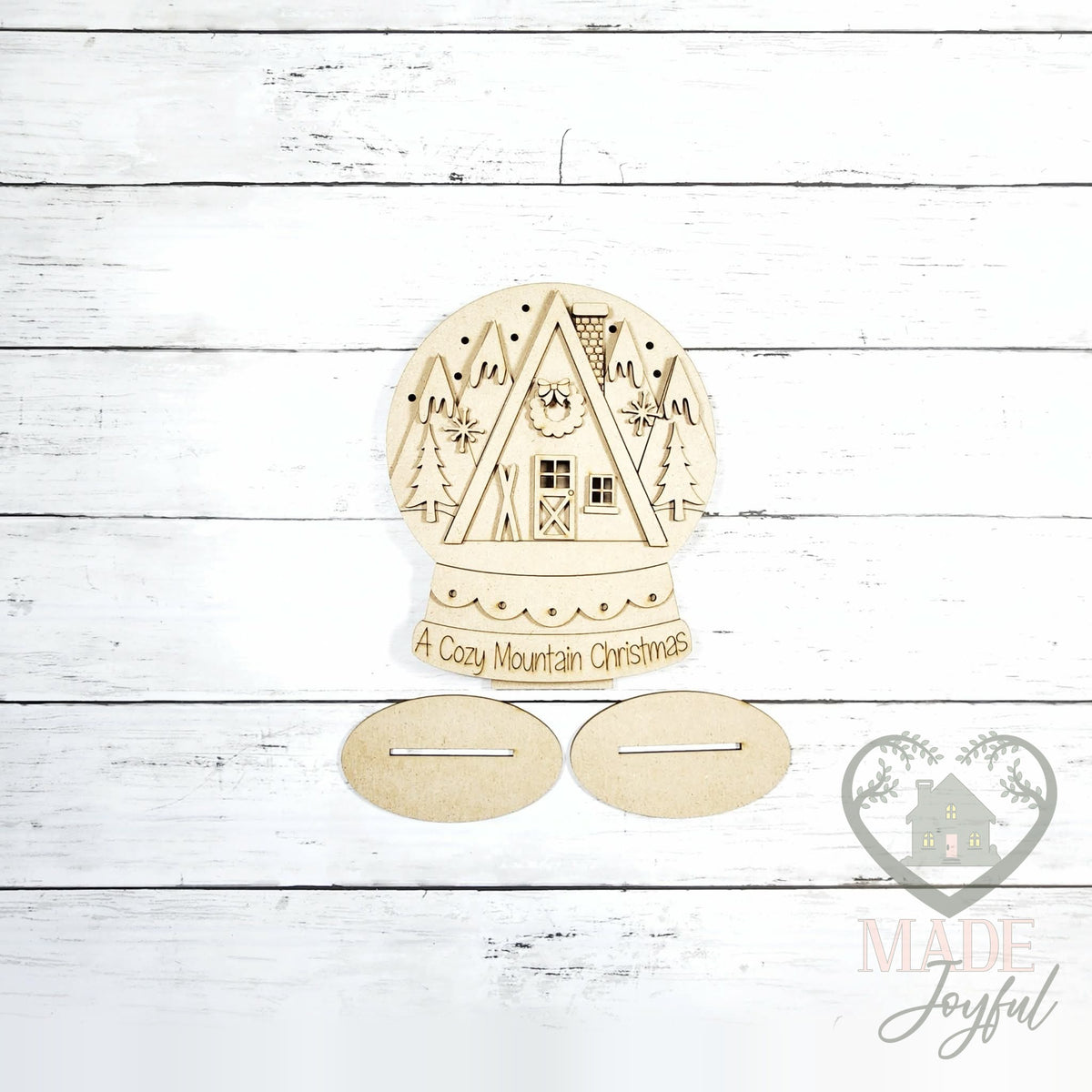 Unfinished laser-cut wood Cozy Mountain Ski Lodge Snow Globe DIY kit, ready to paint at a DIY party in Williamson County, TN.
