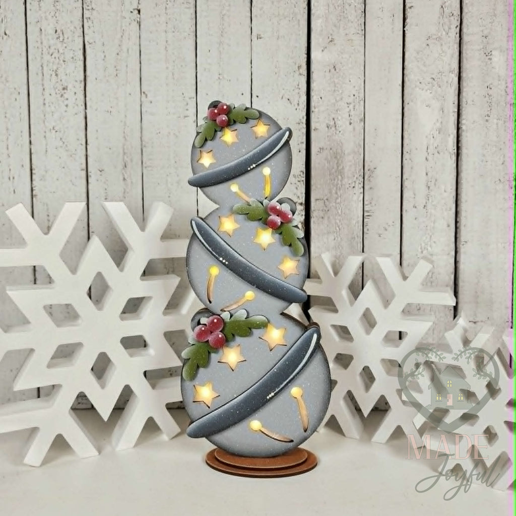 Lighted jingle bell shelf sitter with stacked silver bells and holly, hand-painted in Brentwood, TN.