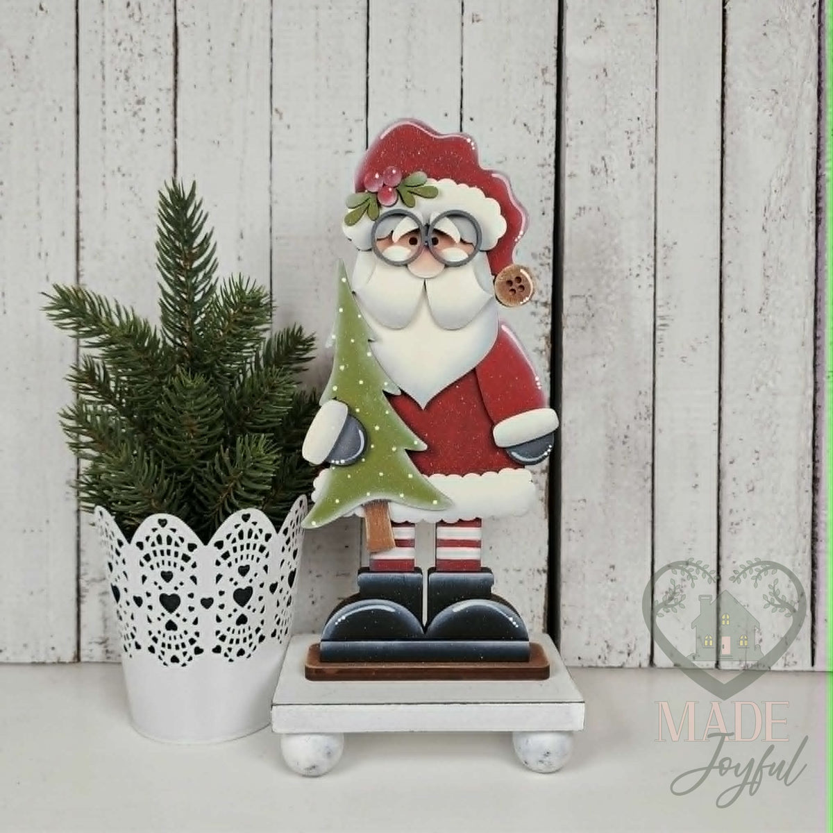 Standing St. Nick shelf sitter holding a Christmas tree, hand-painted in Brentwood, TN.