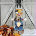 Scarecrow votive shelf sitter holding an LED candle, hand-painted in Brentwood, TN.