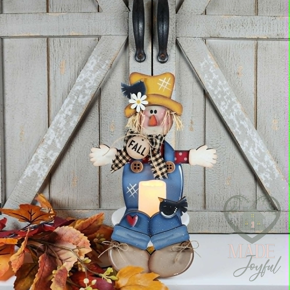 Scarecrow votive shelf sitter holding an LED candle, hand-painted in Brentwood, TN.