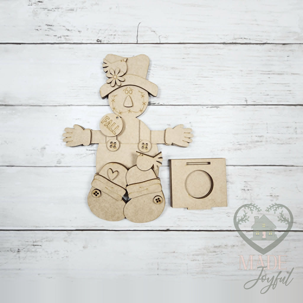 Unfinished laser-cut wood Scarecrow Votive Shelf Sitter DIY kit, ready to paint at a DIY party in Williamson County, TN.