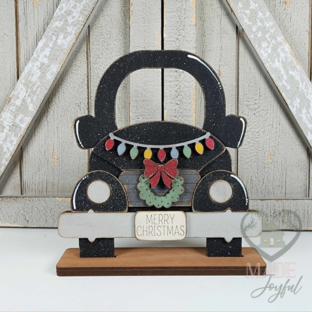 Black vintage truck with Merry Christmas lights and wreath, hand-painted in Brentwood, TN.