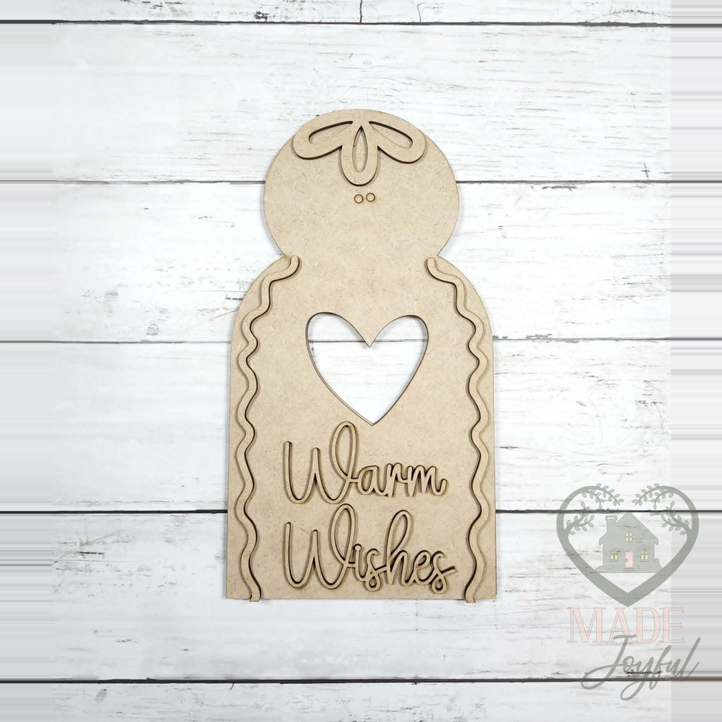 Unfinished laser-cut wood Warm Wishes Gingerbread Shelf Sitter DIY kit, ready to paint at a DIY party in Williamson County, TN.