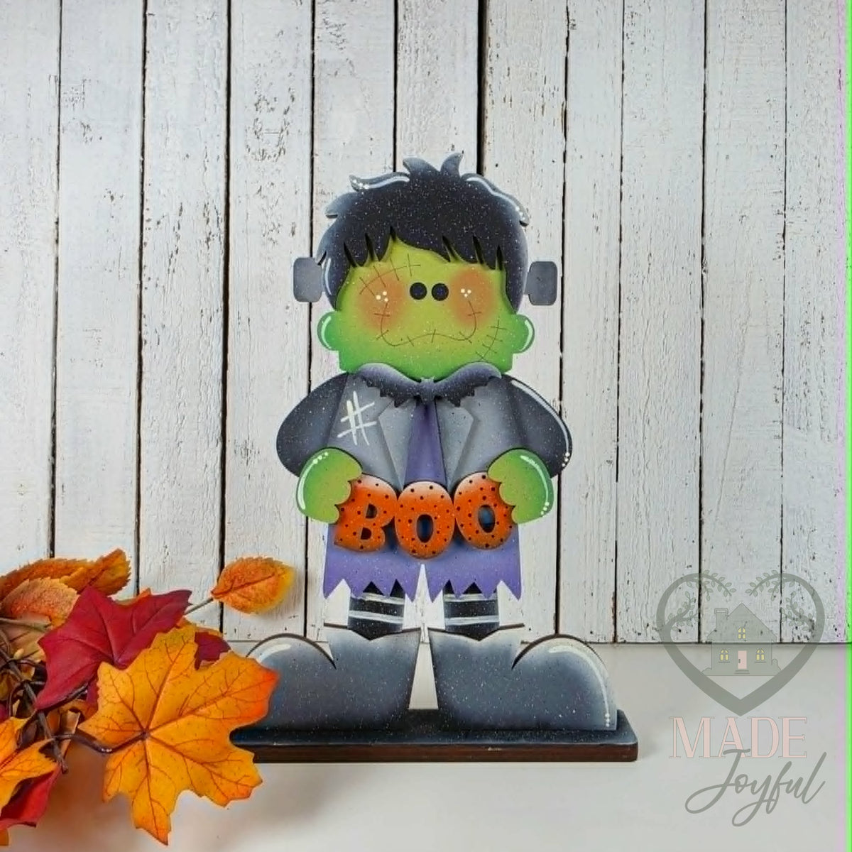 Frankie Frankenstein shelf sitter holding BOO sign, hand-painted in Brentwood, TN.
