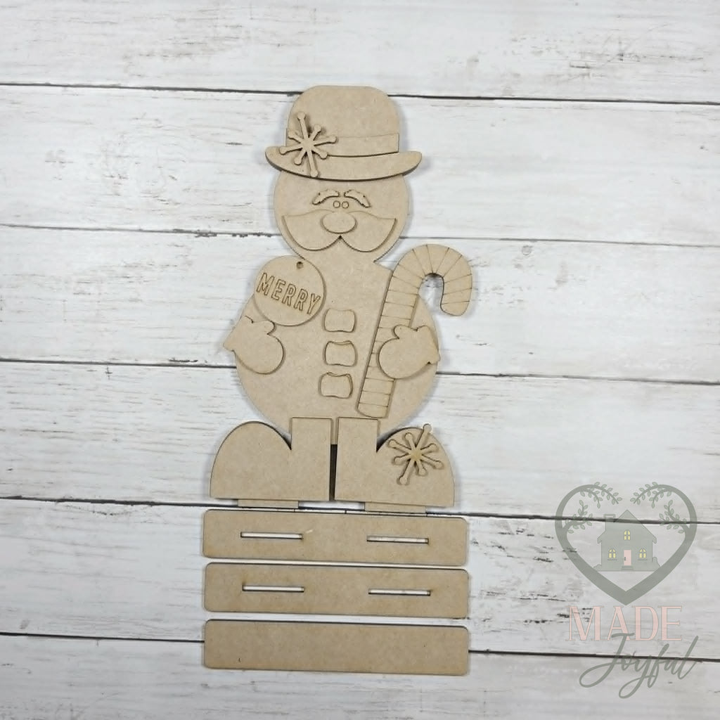 Unfinished laser-cut wood Sir Winston Snowmen Shelf Sitters DIY kit (Merry pieces), ready to paint at a DIY party in Williamson County, TN.