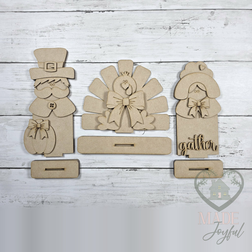 Unfinished laser-cut wood Thanksgiving Pilgrim & Turkey Shelf Sitters DIY kit, ready to paint at a DIY party in Williamson County, TN.