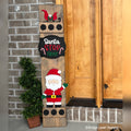 Santa Stop Here interchangeable porch leaner with a sleigh, a Santa Stop Here sign, and a waving Santa on a stained wood base by a front door