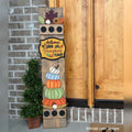Autumn interchangeable porch leaner with fall leaves, an Autumn Leaves and Pumpkins Please sign, and stacked pumpkins on a stained wood base