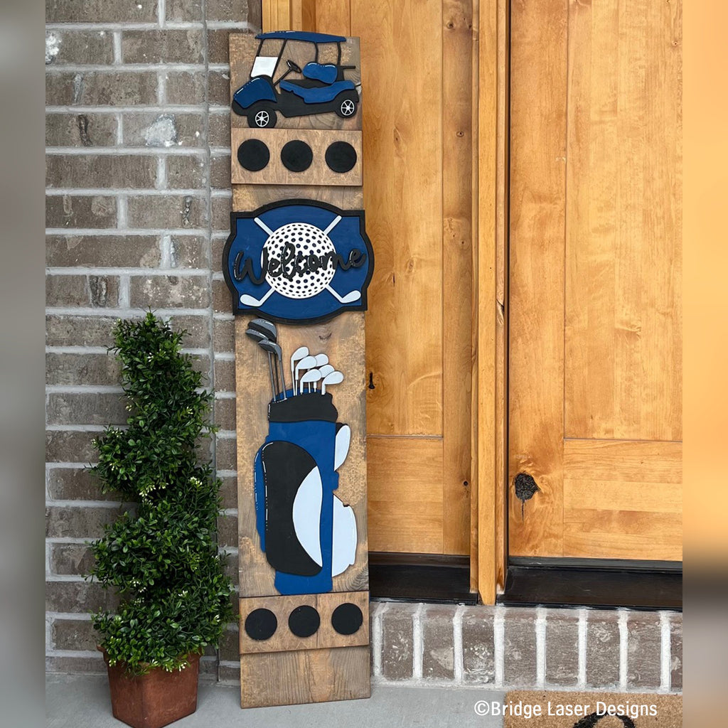 Golf interchangeable porch leaner with a golf cart, a golf ball and crossed clubs sign, and a navy golf bag on a stained wood base by a front door