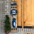 Golf interchangeable porch leaner with a golf cart, a golf ball and crossed clubs sign, and a navy golf bag on a stained wood base by a front door