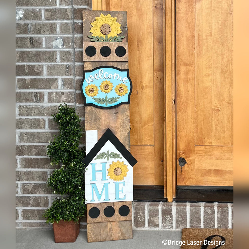 Sunflower interchangeable porch leaner with a sunflower, a Welcome sign, and a farmhouse HOME sign with a sunflower on a stained wood base