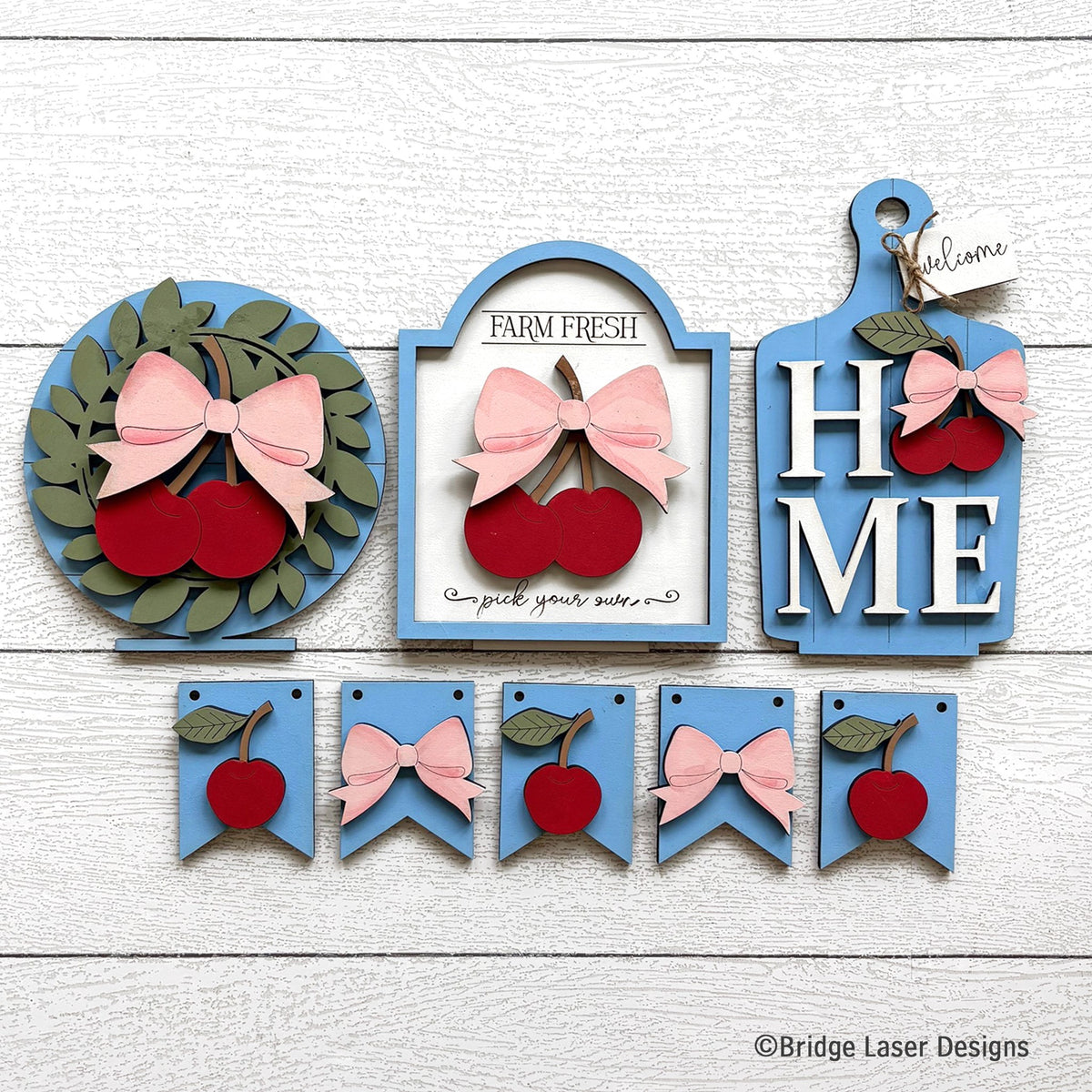 Cherries interchangeable bench decor set with a cherry wreath, a Farm Fresh cherries sign, a HOME sign, and a cherry and bow banner