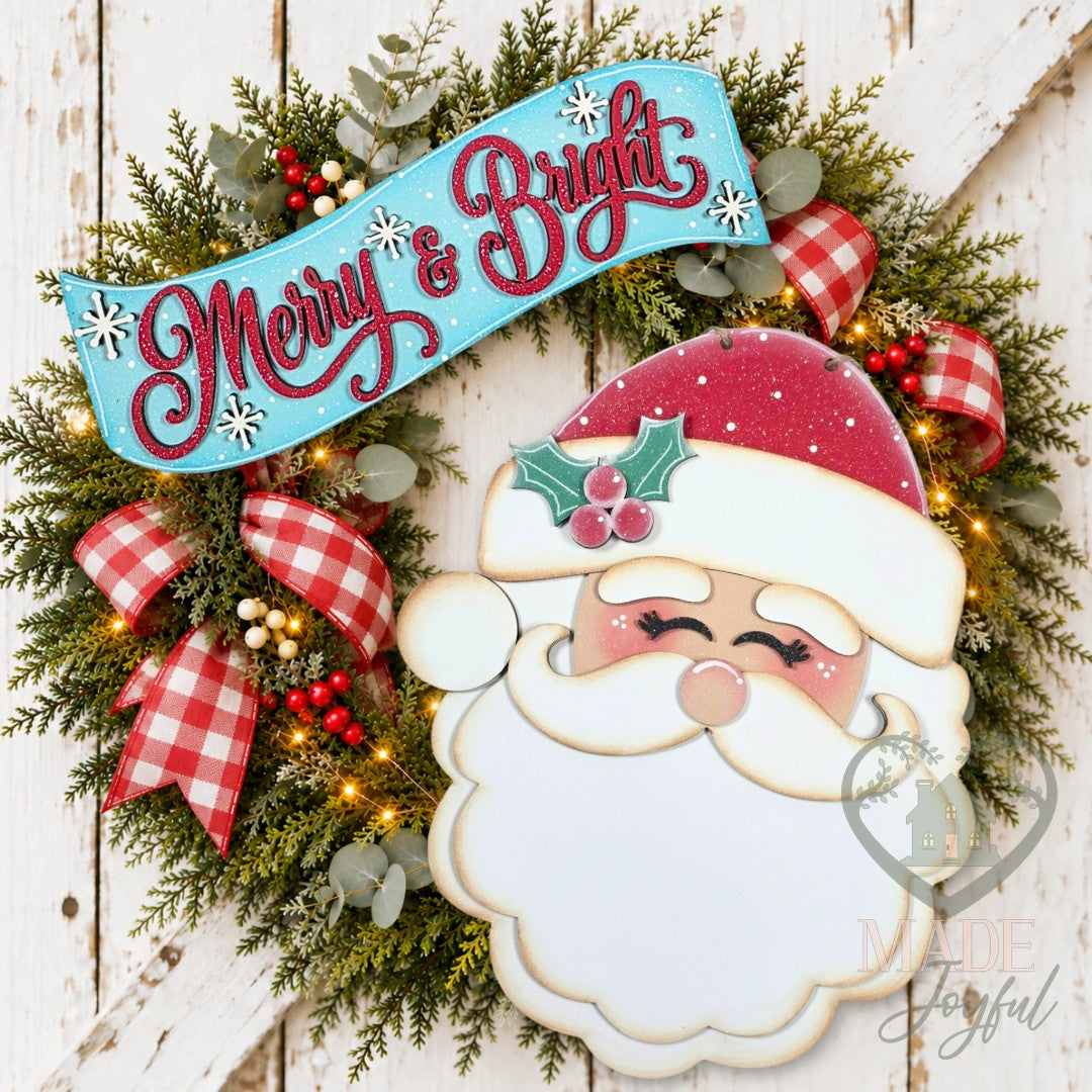 Santa face door hanger on a wreath with a Merry & Bright script banner and plaid bows, hand-painted in Brentwood, TN.