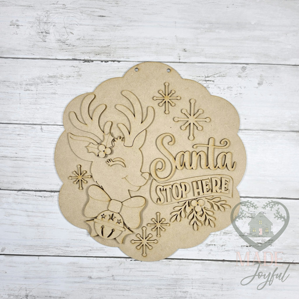 Unfinished laser-cut wood Santa Stop Here Vintage Reindeer Door Hanger DIY kit, ready to paint at a DIY party in Williamson County, TN.