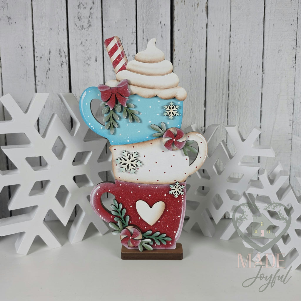 Stacked hot cocoa mugs shelf sitter in aqua, white, and red with whipped cream and peppermints, hand-painted in Brentwood, TN.