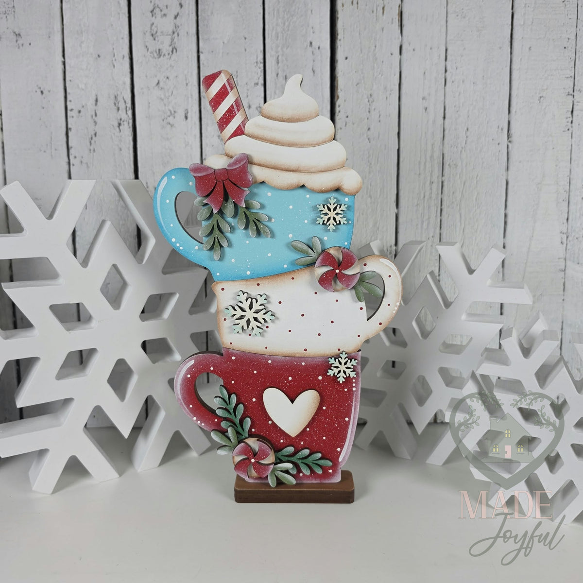 Stacked hot cocoa mugs shelf sitter in aqua, white, and red with whipped cream and peppermints, hand-painted in Brentwood, TN.