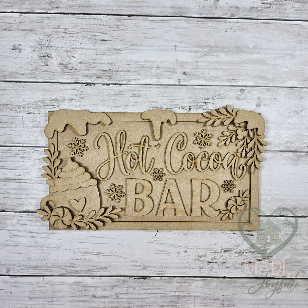 Unfinished laser-cut wood Hot Cocoa Bar Sign DIY kit, ready to paint at a DIY party in Williamson County, TN.