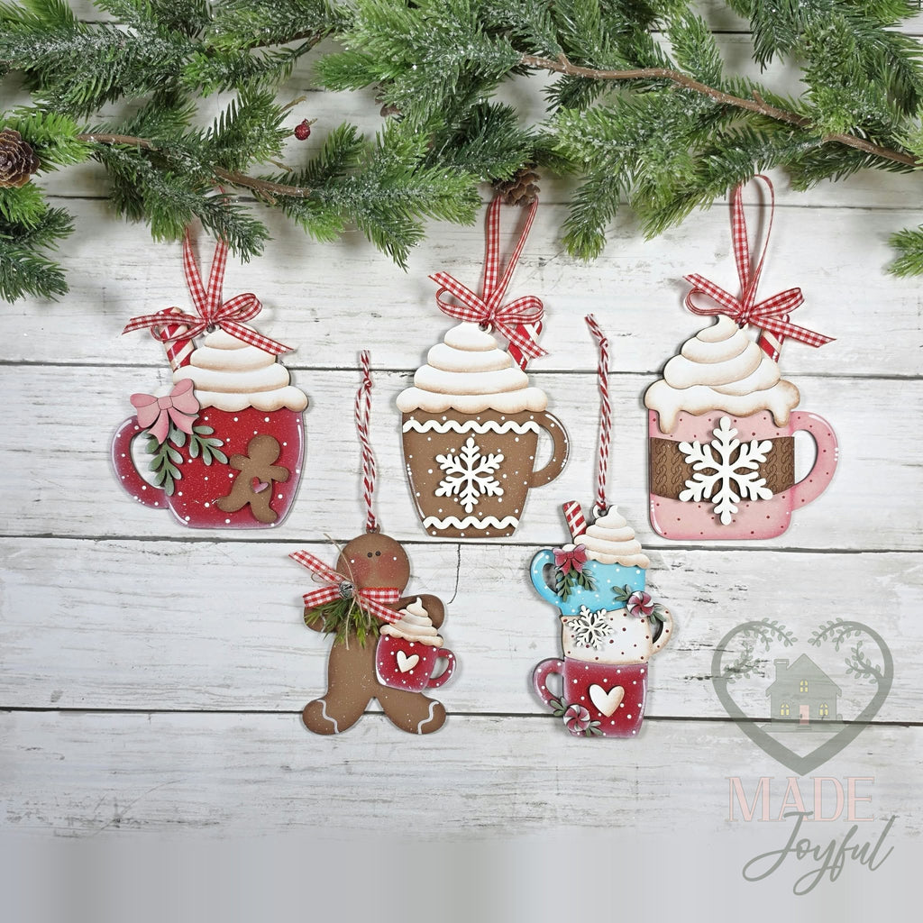 Hot cocoa ornament set: red gingerbread mug, snowflake mug, pink mug, gingerbread man, and stacked mugs with gingham bows, hand-painted in Brentwood, TN.