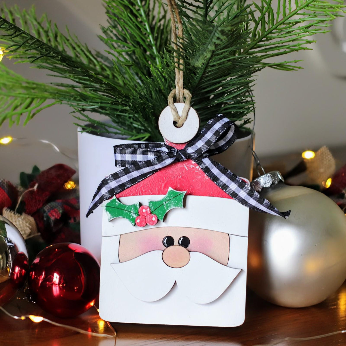 Hand-painted Santa and friends breadboard ornaments with Santa, reindeer, elves, penguins, a gingerbread man and a snowman, which can also hold gift cards, hand-painted in Brentwood, TN.