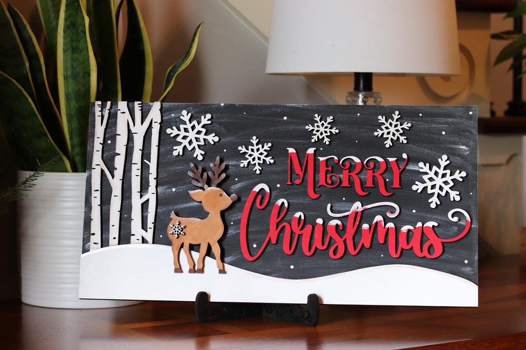 Oh Deer Merry Christmas mantel sign with reindeer, snowflakes, and red script, hand-painted in Brentwood, TN.